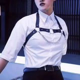 Model wearing the chain-detail harness over a short-sleeve white shirt